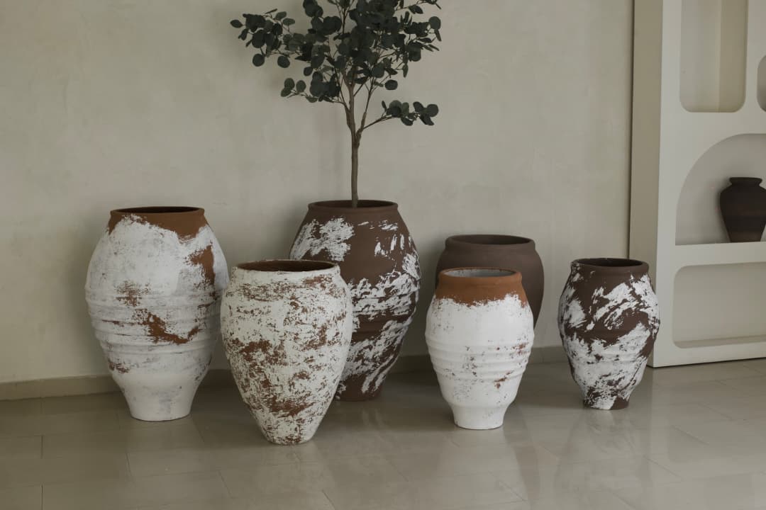 Best planters and artificial plant combo featuring rustic handcrafted terracotta pots with white textured finish for modern home decor.