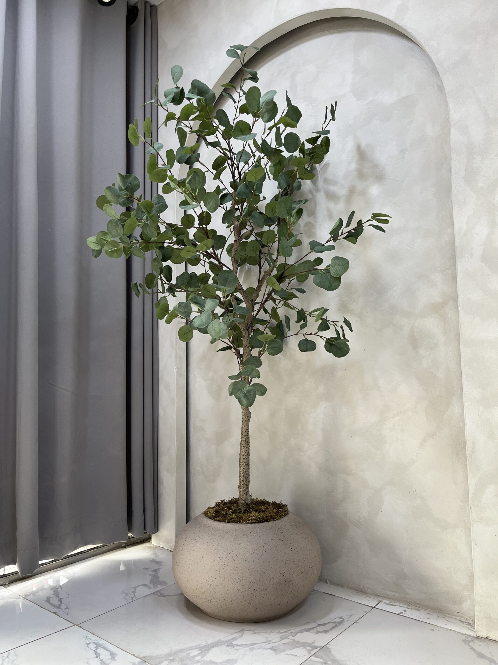 Plant Shop Near Me – Artificial eucalyptus tree displayed in a nude planter for contemporary interior styling.