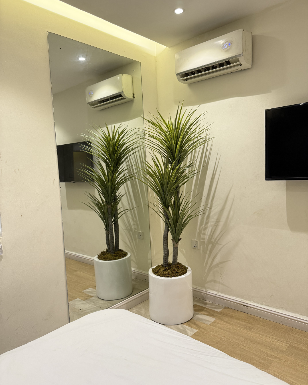 Plant Shop Near Me – Artificial yucca plant in a white decorative planter for modern indoor spaces.