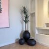 Matte Black Ampora Pot Paired with Granite Small and Flat Orbis Pots, Styled with Artificial Slim Yucca Tree Matte Black Ampora Pot Paired with Granite Small and Flat Orbis Pots, Styled with Artificial Slim Yucca Tree
